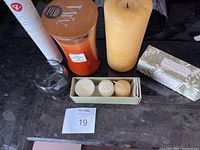 Photo showing the various candles, incense sticks container, votive holder, and herbal sachets on a black surface.