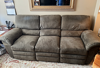 Front view of olive microfiber double recliner sofa showing three seats and plush cushioning.
