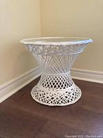 Front side view showing the metal lattice frame and round glass top