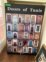 Overall framed print showing 25 photographic images of doors from Tunis arranged in a 5x5 grid with 'Doors of Tunis' title