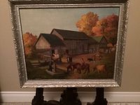 Full view of the oil painting showing the farm scene with boy, well, and animals, framed in ornate silver-painted frame.