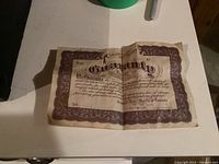 Guarantee certificate for the Renulife Violet Ray device, shows company and warranty information on aged paper.