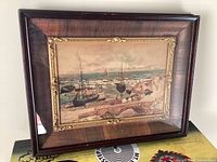 Front view of painting and frame leaning against wall.