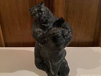 Front view of detailed polar bear soapstone sculpture showing the bear's upright posture and textured fur.