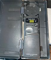 Front view of the RadioShack 40 channel emergency citizens band radio inside its plastic carrying case showing the buttons, speaker grill, and digital display.