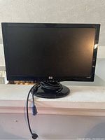 Front view of HP S1931a monitor showing screen, bezel, and attached VGA cable.