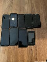 Phones front view on wooden surface showing screen conditions and damages