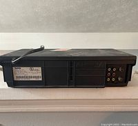 Back view of Symphonic VCR player showing power cord, label, and audio-video ports