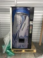 Front view of a locked vending machine for cold drinks showing coin slot, selection buttons and graphic panel with ice and drink can.