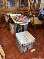 Full lot view showing stacked boxes and pans including Martha Stewart and T-Fal items.