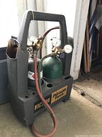 Front view of Victor portable torch kit in molded carrying case showing two gas cylinders, regulators, and hoses