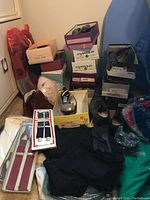 Various women's shoes in boxes and loose on floor, several brands, size 8 to 8.5
