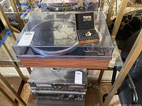 Overview of Acoustic Research turntable on display shelf with clear dust cover closed