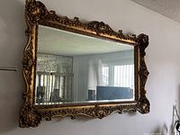 Full view of rectangular wall mirror hanging on wall
