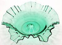 Front view of clear green glass bowl with ruffled edges and visible pontil mark.