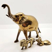 Photo of all three brass animal figurines together, showing relative size and shine of brass surface