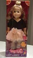 Front view of the doll in box showing full body and outfit.