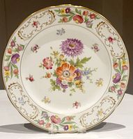 Full view of the Hammersley floral round charger plate with detailed floral pattern and gold ornamental border.