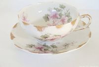 Top and side view of Limoges wide mouth cup with floral pattern and gold gilding on saucer