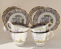 Four bone china footed tea cups and four matching saucers with Silver Birch pattern by Royal Albert, arranged for display showing detailed pattern and gold trim.