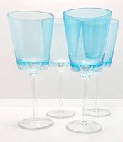 Four turquoise pinstripe goblets standing together showing shape and color.