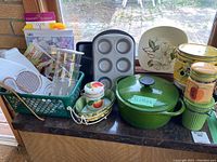 Photo showing full set of kitchen items including green enameled pot, canisters, baking tray, plastic containers, and small ceramic items.