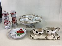 Full view of all items in the lot showing cream and sugar set with tray, divided serving tray, salt and pepper shakers, and decorative plate.