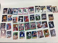 Array of 40 baseball sports cards arranged in rows showing various players predominantly in baseball action and posed shots, some with autographs or special edition markings.