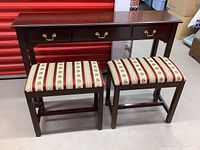Full view of the Bombay hall table with two upholstered benches placed in front, showing the entire set.