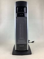 Front full view of the Bonaire space heater showing its tall tower design with black and silver colors and mesh grille.