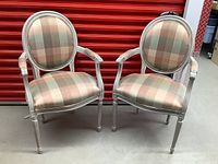 Front view of both chairs side by side against red storage unit door