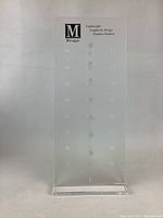 Front view of clear acrylic glasses display stand with Miraggio branding