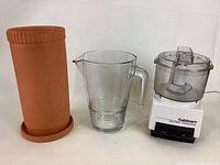 Photo of the clay wine cooler, glass water jug, and Cuisinart Mini food processor together showing all three items from the front