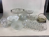 Multiple pieces of assorted glassware photographed on plain background for condition and detail assessment