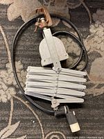 Full view of the heavy duty accordion pulley showing the accordion metal arm mechanism, cable, and clamp.
