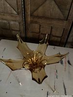 Top-down view highlighting the star-like form and swirled detailing in the center of the amber glass dish.