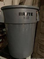Full front view of large gray Rubbermaid Brute waste bin showing overall size and shape