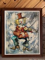 Full view of framed painting showing the clown playing the violin against textured blue and gray tones.