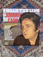 Front cover of 'I Walk The Line' vinyl album showing color photo of Johnny Cash and track list