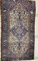 Full view of vintage wool carpet showing entire design and wear