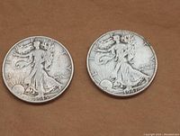 Obverse side of two Walking Liberty Half Dollar coins showing Lady Liberty design dated 1945 and 1947