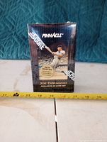 Photo of sealed Joe DiMaggio Pinnacle Score limited edition collector card box with measuring tape showing height.