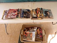 Multiple stacks of Drummer magazines spread on a table, showing colorful covers with drummers and drum equipment featured.
