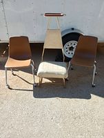 Photo of two brown children's rolling student chairs and mid-century suit valet showing front view of all items.