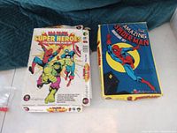 Photo showing the original boxes for two Colorforms superhero play sets, one Marvel Super Heroes and one The Amazing Spider-Man.