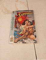 Front cover of comic book showing Superman injured, embraced by Lois Lane, titled 'The Death of Superman'.