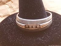 Front view of sterling silver ring showing five small clear stones set in a horizontal line.