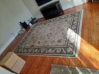 Full room view of rug on hardwood floor