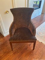 Front view of brown velvet armchair showing full shape