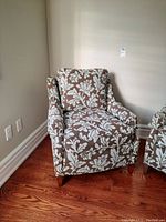 Armchair front left three-quarter view showing overall upholstery pattern and wooden tapered legs